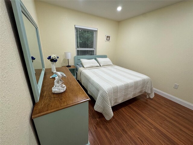 bedroom with hardwood / wood-style floors