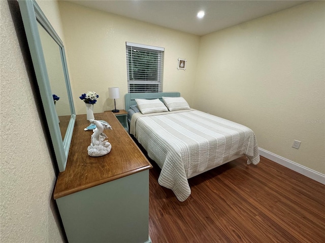 bedroom with recessed lighting, baseboards, and wood finished floors