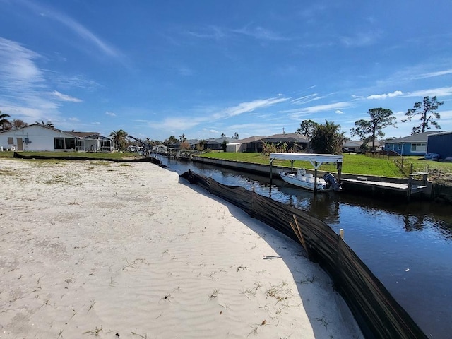 view of dock with a water view and a residential view