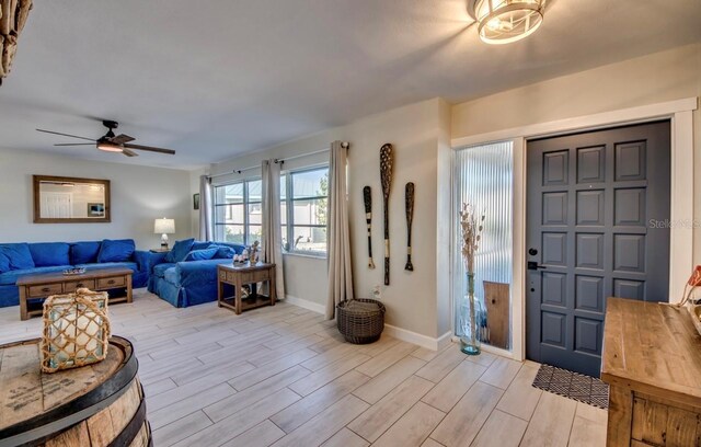 foyer entrance featuring ceiling fan and light hardwood / wood-style flooring