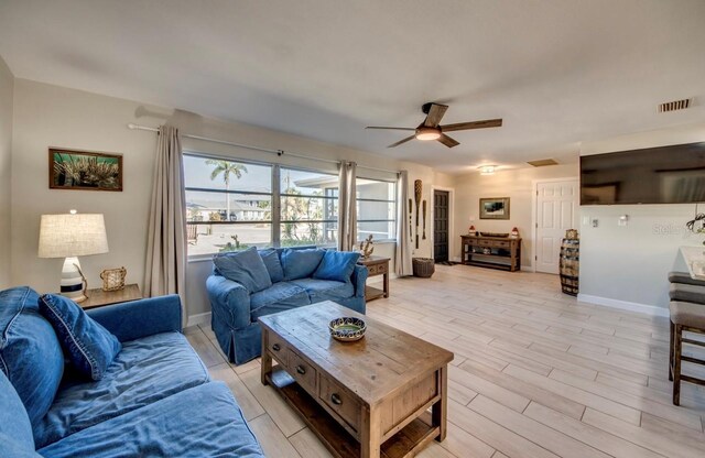 living room featuring ceiling fan and light hardwood / wood-style flooring