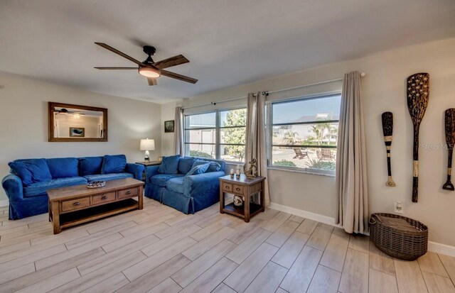 living room with light hardwood / wood-style floors and ceiling fan