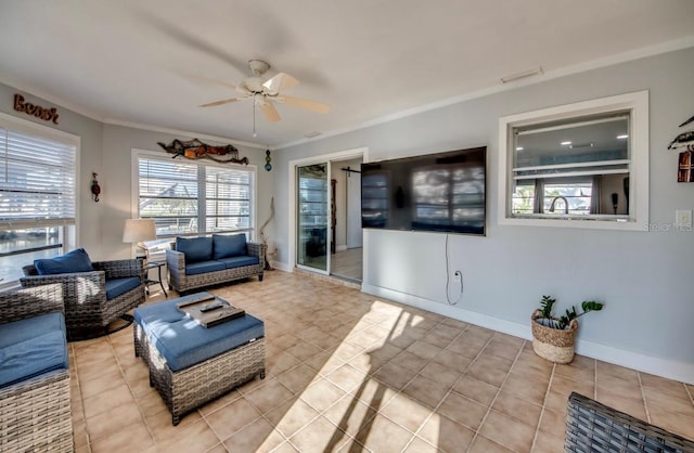 living room with light tile patterned floors, ceiling fan, and crown molding