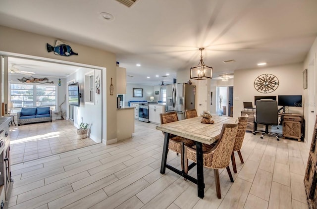 dining space with wood tiled floor, baseboards, a ceiling fan, and recessed lighting