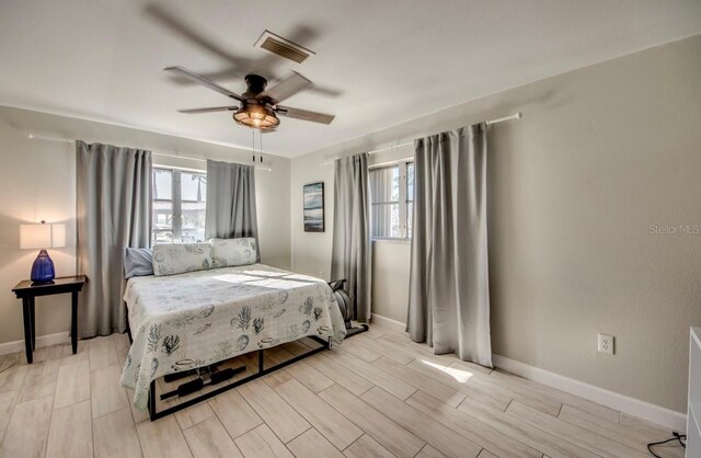 bedroom with ceiling fan and light hardwood / wood-style floors