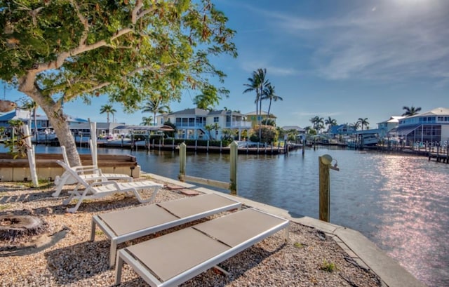 dock area featuring a water view and a residential view