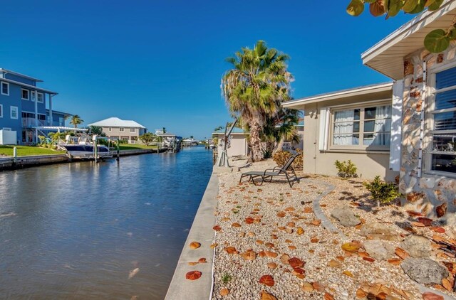 property view of water with a dock