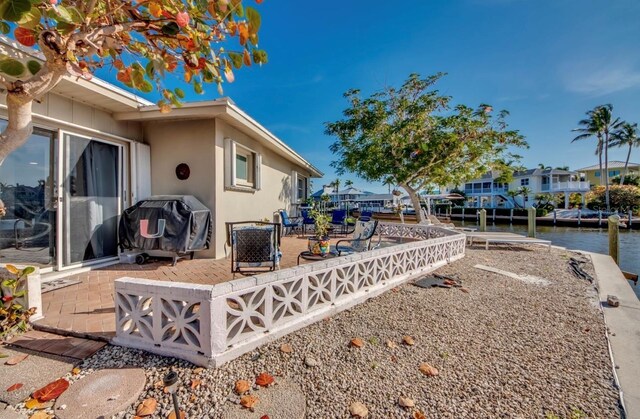 view of yard featuring a water view and a patio