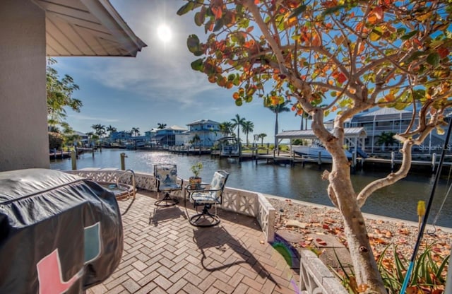 exterior space with a water view and a patio area