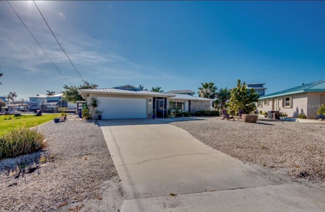 ranch-style house with a garage and driveway