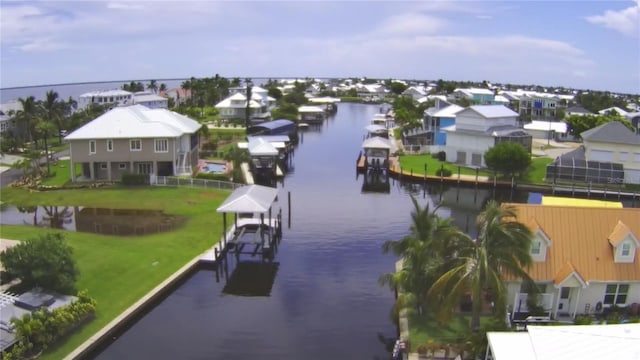 drone / aerial view featuring a water view and a residential view