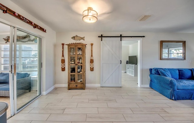 interior space featuring a barn door and a healthy amount of sunlight