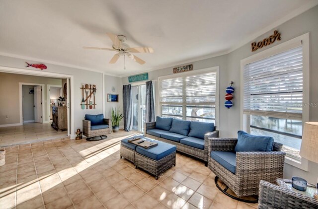 tiled living room featuring crown molding, ceiling fan, and a healthy amount of sunlight