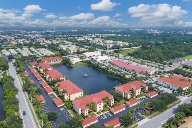 drone / aerial view featuring a residential view and a water view