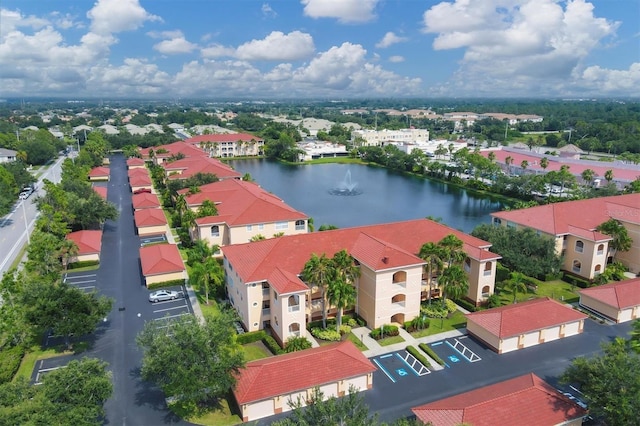 birds eye view of property with a water view and a residential view