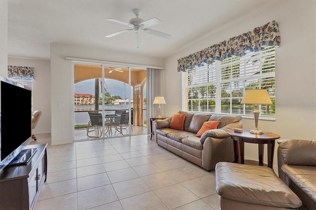 living room featuring light tile patterned flooring, a ceiling fan, and baseboards