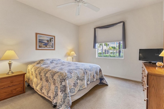 bedroom with light carpet, a ceiling fan, and baseboards