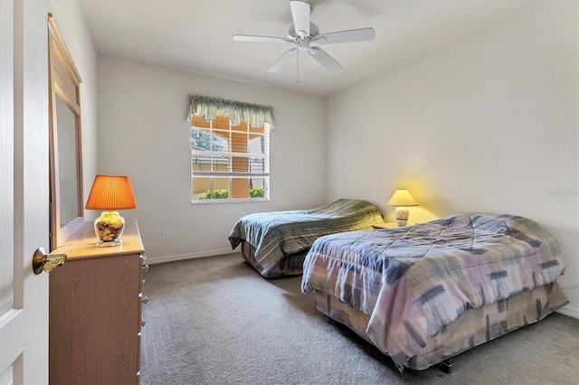 carpeted bedroom with baseboards and a ceiling fan