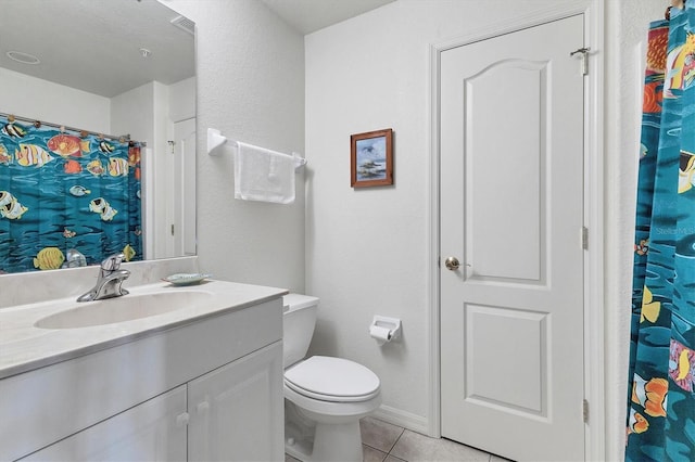 bathroom featuring tile patterned flooring, baseboards, vanity, and toilet