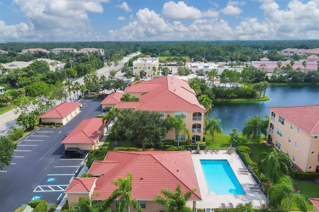 birds eye view of property with a water view and a residential view