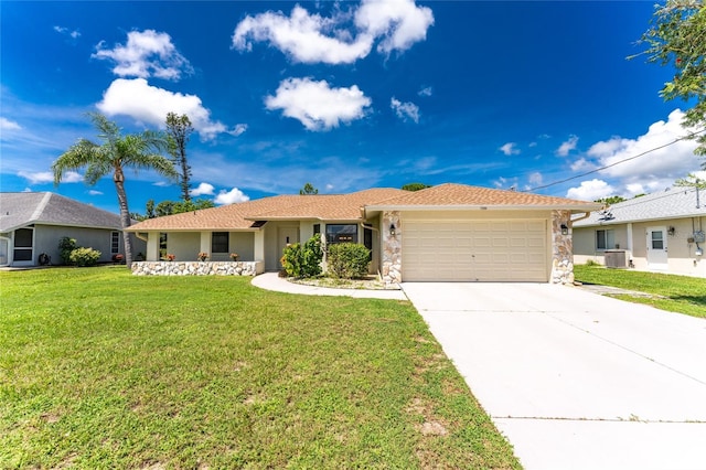 ranch-style house featuring concrete driveway, stone siding, an attached garage, central air condition unit, and a front lawn