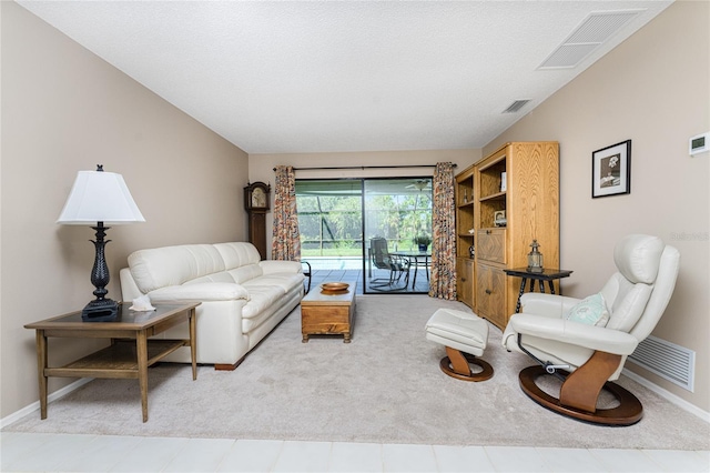 living area with lofted ceiling, visible vents, and baseboards