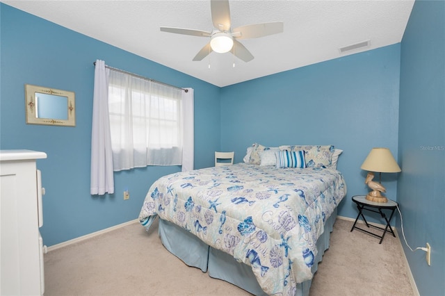 bedroom featuring carpet, visible vents, a ceiling fan, a textured ceiling, and baseboards