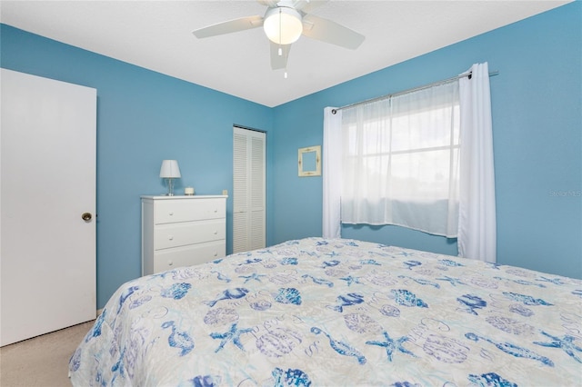 bedroom with carpet floors, a ceiling fan, and a closet