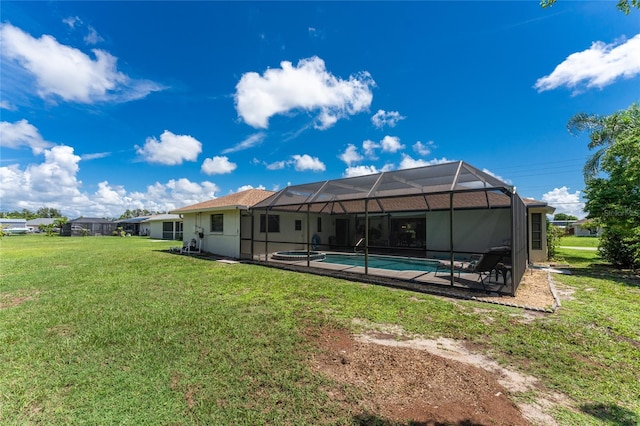 back of house with an outdoor pool, a lanai, a yard, a patio area, and stucco siding