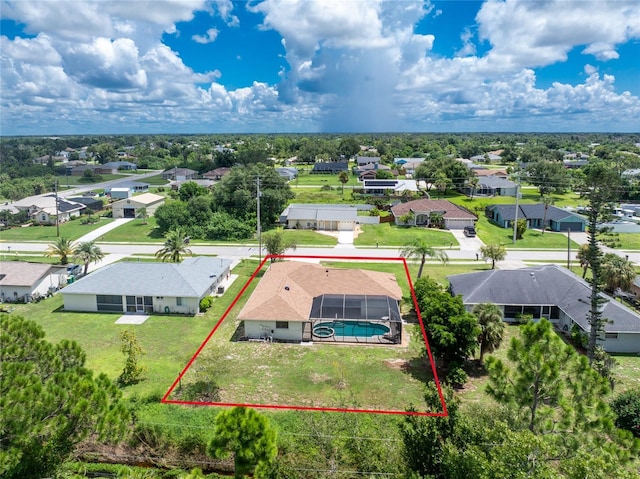 birds eye view of property with a residential view