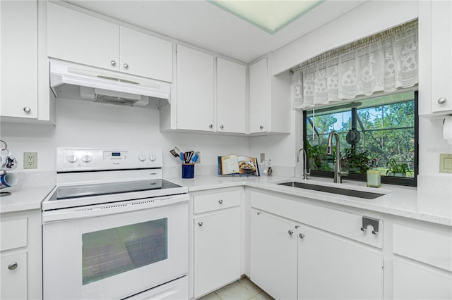 kitchen featuring electric stove, light countertops, under cabinet range hood, white cabinetry, and a sink