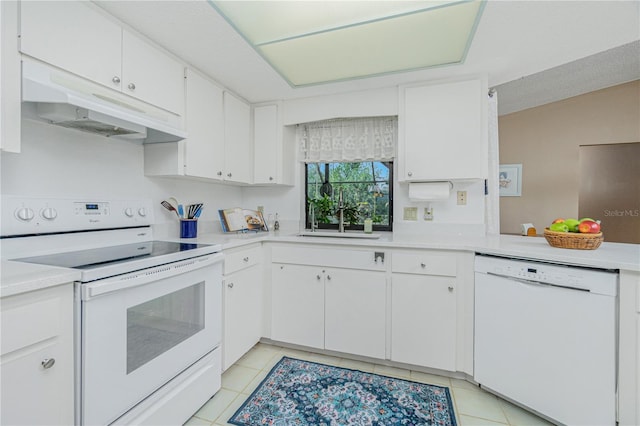 kitchen featuring light tile patterned floors, light countertops, white appliances, and under cabinet range hood