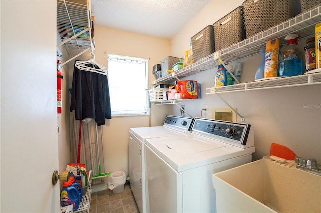 clothes washing area with laundry area, independent washer and dryer, a sink, and tile patterned flooring