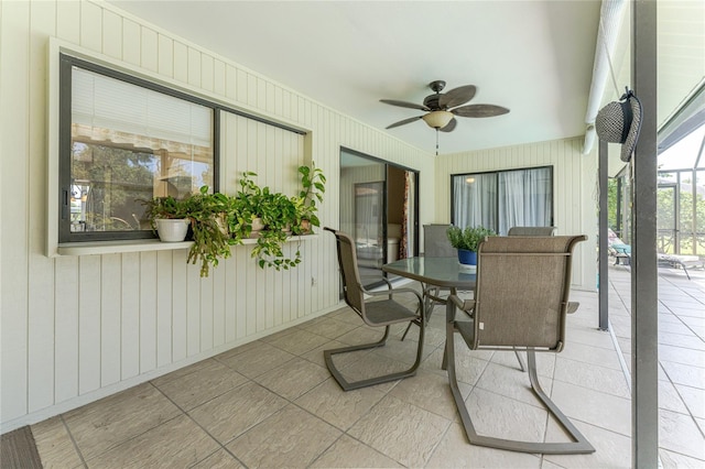 sunroom featuring ceiling fan