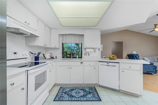 kitchen with a peninsula, white appliances, white cabinets, open floor plan, and light countertops