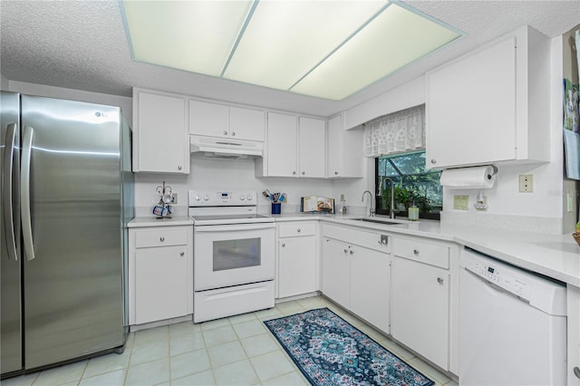 kitchen featuring light countertops, white cabinetry, a sink, white appliances, and under cabinet range hood