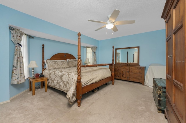 bedroom featuring carpet, a textured ceiling, baseboards, and a ceiling fan