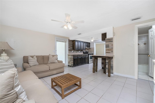 tiled living room with ceiling fan