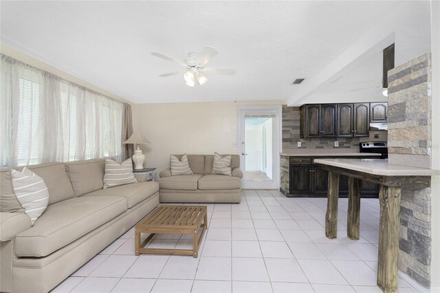 tiled living room featuring ceiling fan and a wealth of natural light