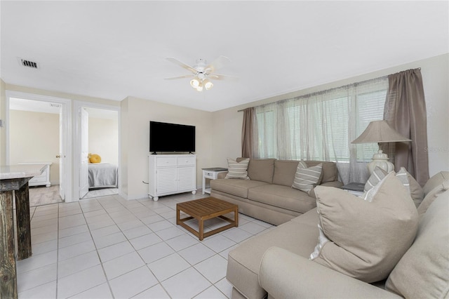 living room featuring ceiling fan and light tile patterned flooring