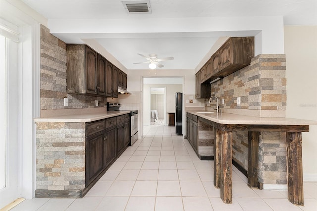 kitchen with decorative backsplash, electric stove, and dark brown cabinetry