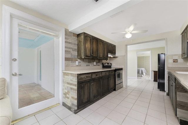 kitchen featuring stainless steel range with electric cooktop, black fridge, dark brown cabinetry, tasteful backsplash, and ceiling fan