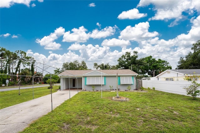 ranch-style house with a carport and a front lawn