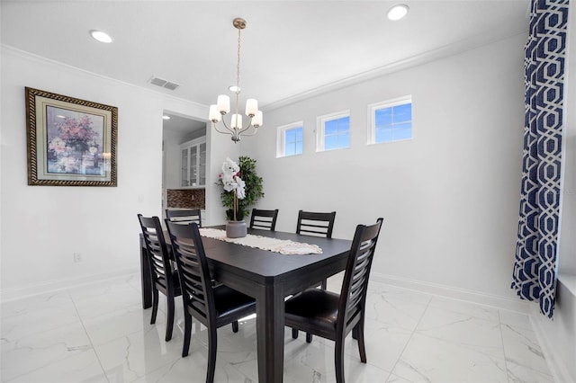 dining room with ornamental molding and a chandelier