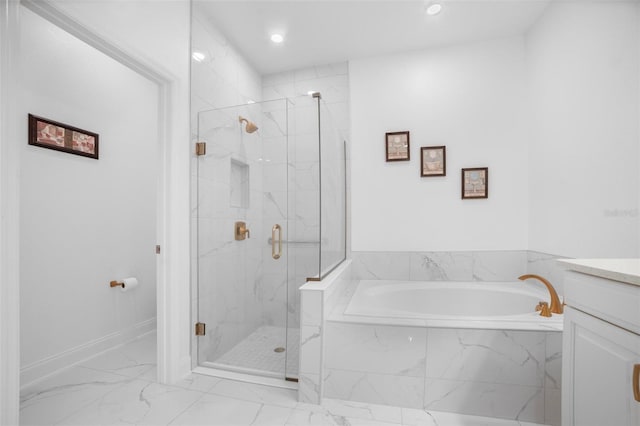 bathroom featuring vanity and independent shower and bath