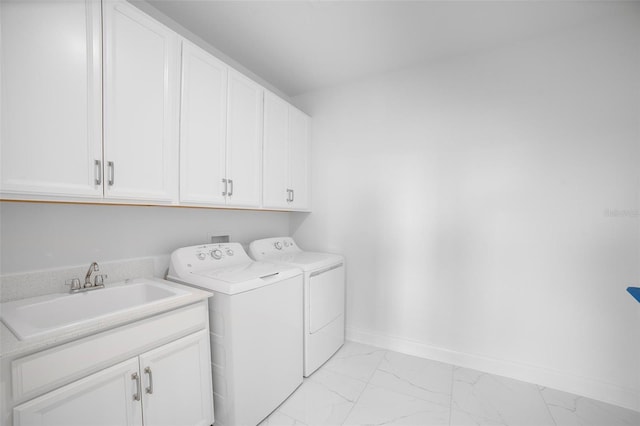 washroom featuring cabinets, washer and dryer, and sink