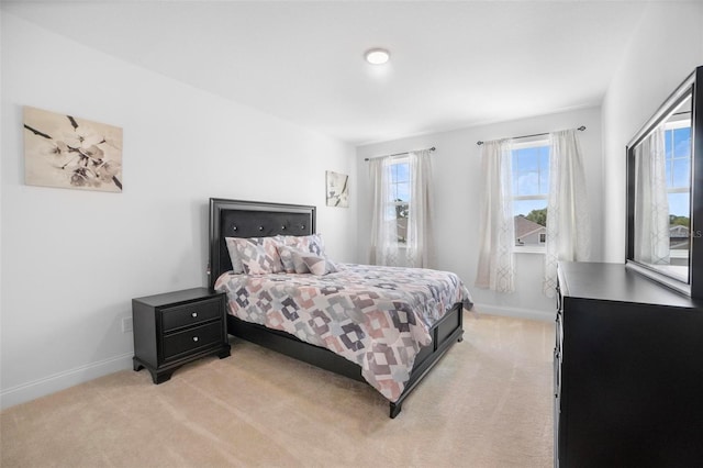 bedroom featuring light colored carpet