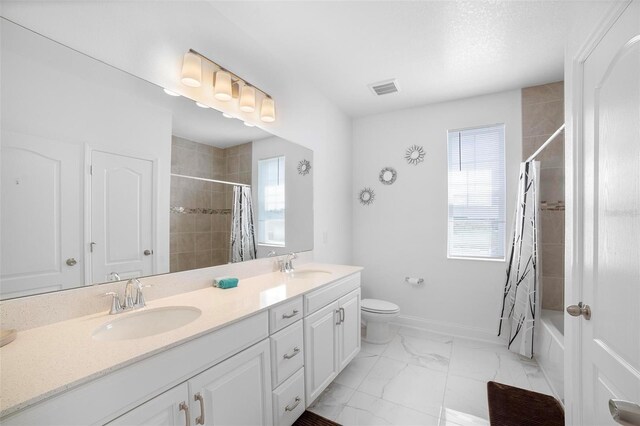 full bathroom featuring vanity, toilet, and shower / bath combo