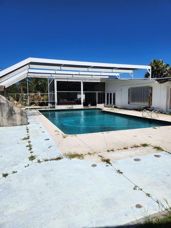 outdoor pool featuring a lanai and a patio