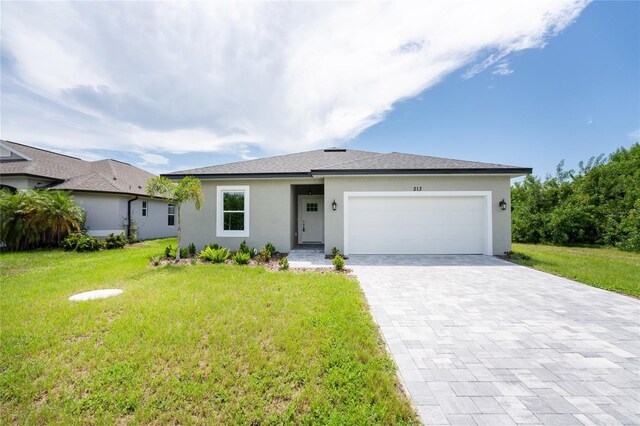 ranch-style home featuring a front lawn and a garage